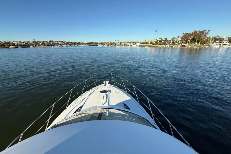 Slide: The Image of Bow view of 2006 Meridian 391 Sedan yacht cruising in a serene harbor. - 55