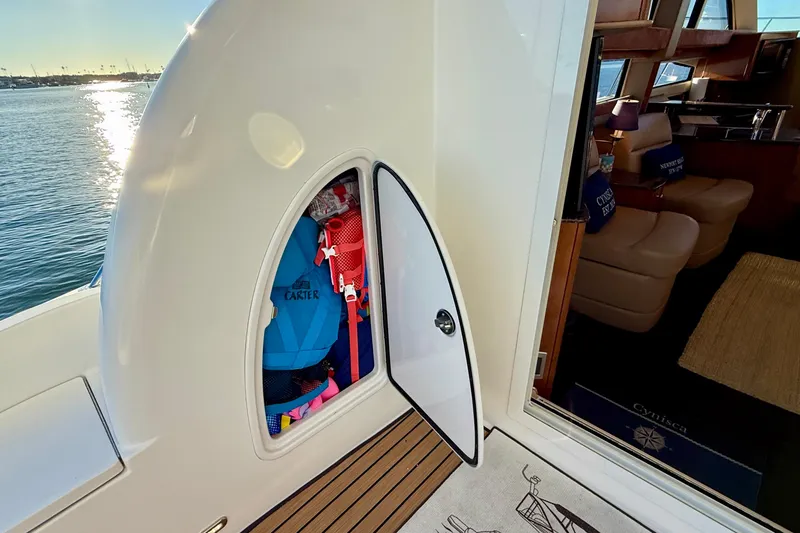 Slide: The Image of 2006 Meridian 391 Sedan yacht with open storage compartment and interior view. - 58