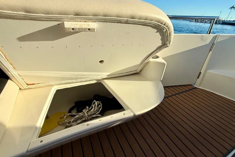 Slide: The Image of Open storage compartment on 2006 Meridian 391 Sedan boat deck with rope and equipment. - 59