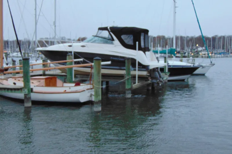 The Image of 2006 Monterey 282 Cruiser docked at a marina, surrounded by other boats. - 0