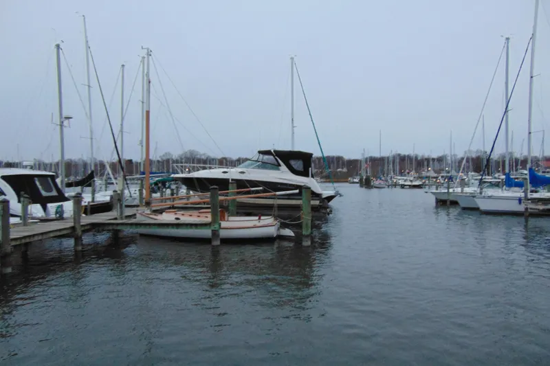 Slide: The Image of 2006 Monterey 282 Cruiser docked at a marina with sailboats. - 2
