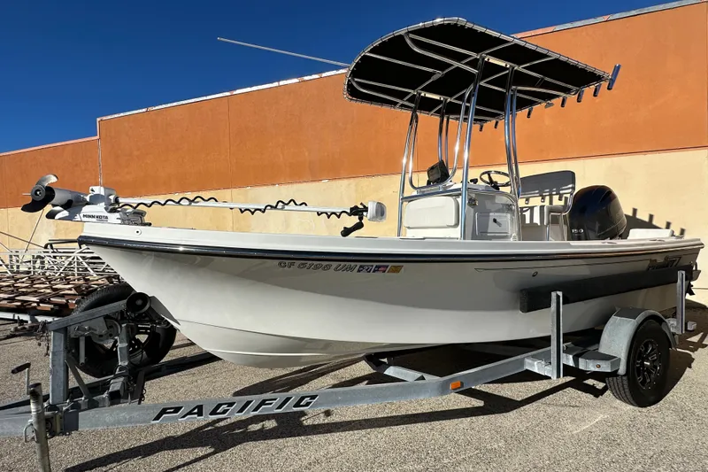 The Image of 2023 Parker 1801 Center Console boat on trailer, featuring a T-top and Minn Kota motor. - 0