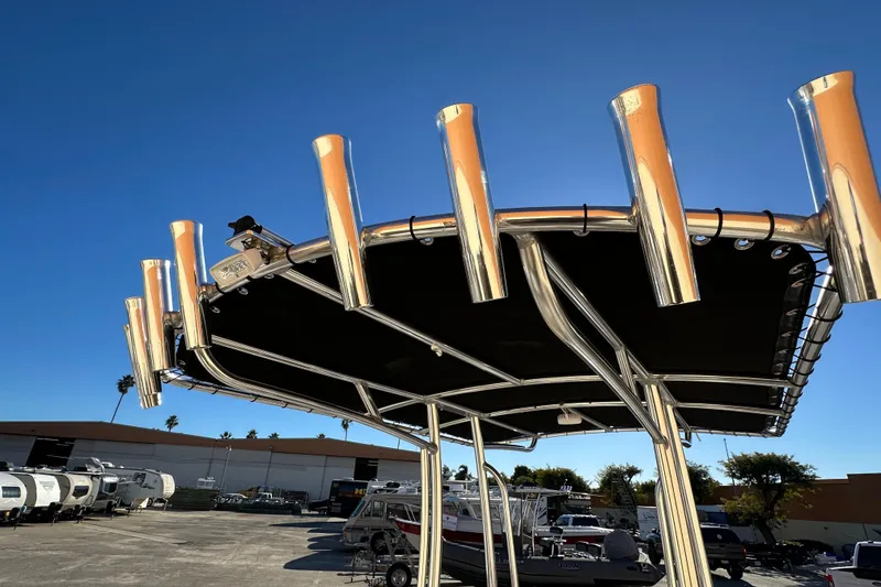 Slide: The Image of 2023 Parker 1801 Center Console boat with T-top and rod holders under clear blue sky. - 12