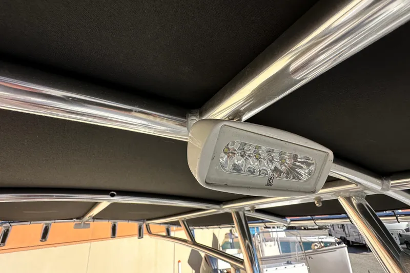 Slide: The Image of LED light fixture on 2023 Parker 1801 Center Console boat's T-top frame. - 13