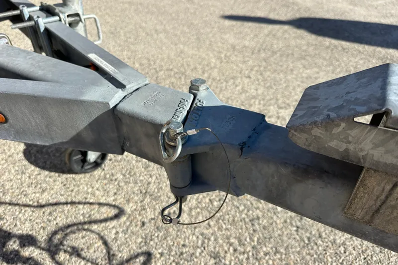 Slide: The Image of Trailer hitch of a 2023 Parker 1801 Center Console boat on pavement. - 19