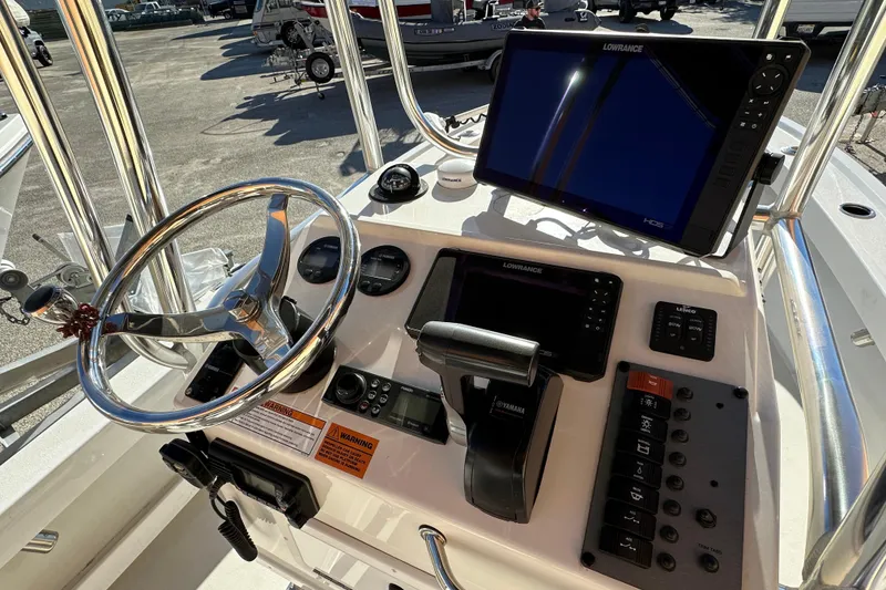 Slide: The Image of 2023 Parker 1801 Center Console boat dashboard with steering wheel and navigation equipment. - 4
