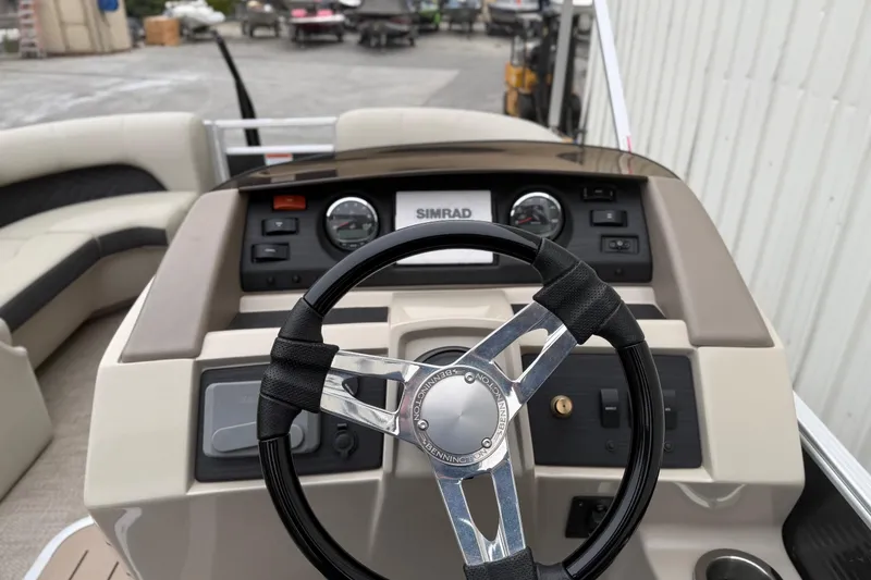 Slide: The Image of 2020 Bennington 22 SSRFBXP boat dashboard with steering wheel and controls. - 11