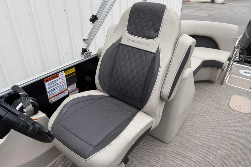 Slide: The Image of 2020 Bennington 22 SSRFBXP boat seat with quilted upholstery and steering controls. - 13