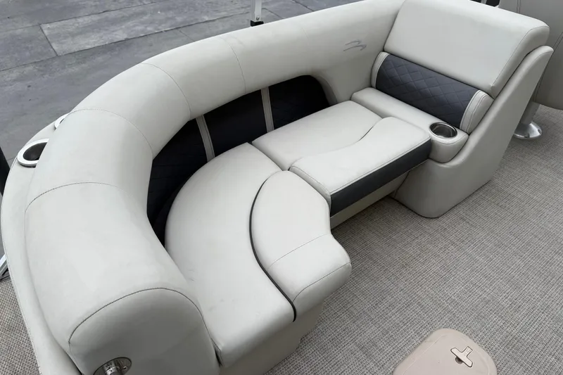 Slide: The Image of Luxurious seating on a 2020 Bennington 22 SSRFBXP pontoon boat, featuring plush upholstery and cup holders. - 16