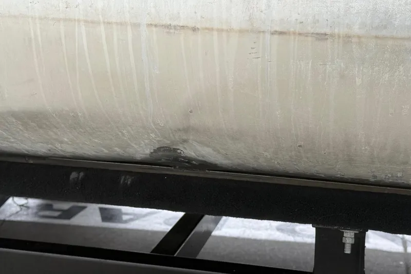 Slide: The Image of 2020 Bennington 22 SSRFBXP pontoon with visible hull damage. - 21