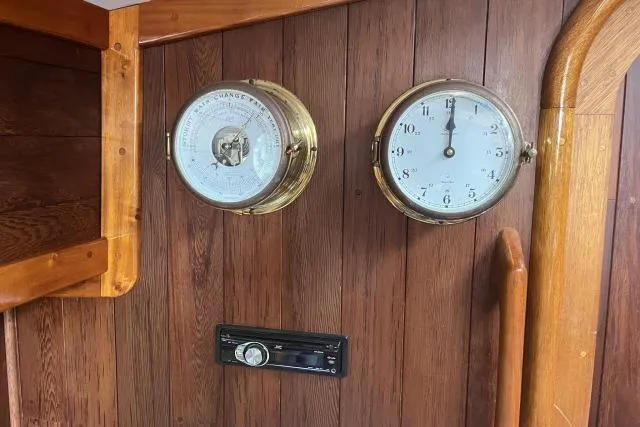 Slide: The Image of 1977 Alajuela A38 interior with barometer, clock, and stereo on wooden paneling. - 12