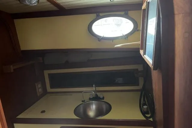 Slide: The Image of 1977 Alajuela A38 yacht interior with sink and porthole window. - 16
