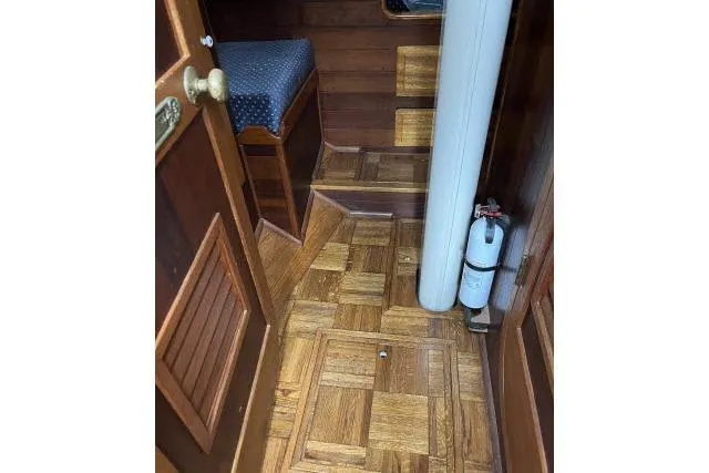 Slide: The Image of Interior of 1977 Alajuela A38 sailboat with wooden flooring and steps. - 17