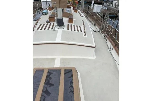 Slide: The Image of 1977 Alajuela A38 sailboat deck with wooden accents and railing. - 25