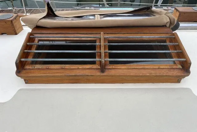Slide: The Image of Wooden hatch on 1977 Alajuela A38 sailboat deck with metal bars. - 27
