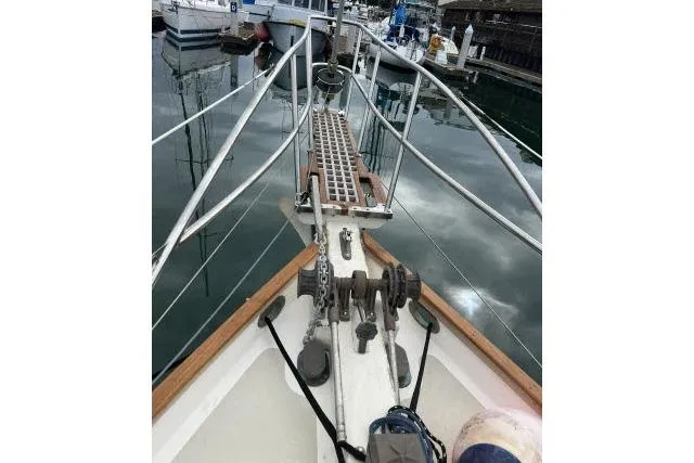 Slide: The Image of Bow of 1977 Alajuela A38 sailboat with anchor chain and marina view. - 29