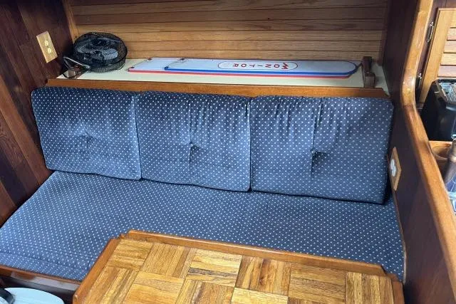 Slide: The Image of 1977 Alajuela A38 interior with blue cushioned seating and wooden accents. - 3