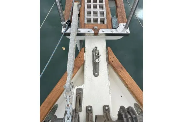 Slide: The Image of Bow of 1977 Alajuela A38 sailboat with anchor chain and wooden deck details. - 30