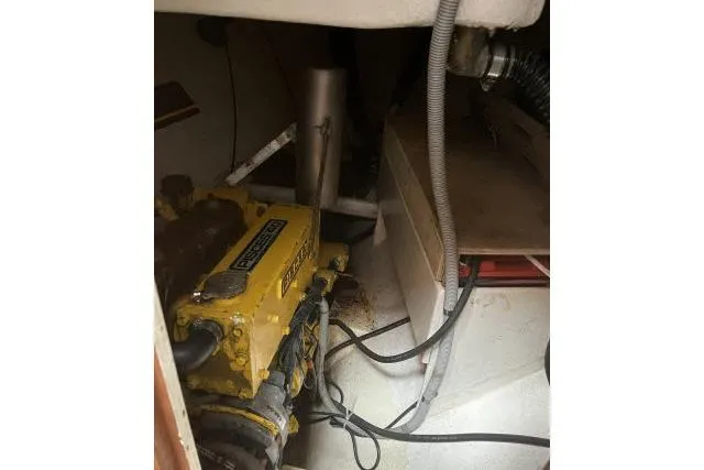 Slide: The Image of Engine compartment of 1977 Alajuela A38 sailboat with yellow Perkins engine. - 32