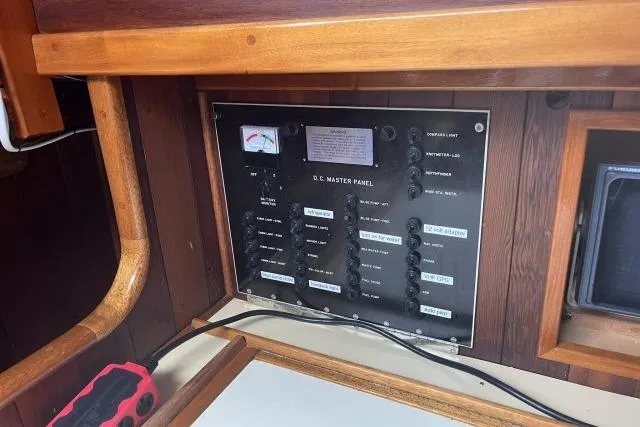 Slide: The Image of Electrical panel inside a 1977 Alajuela A38 boat, featuring various switches and gauges. - 9