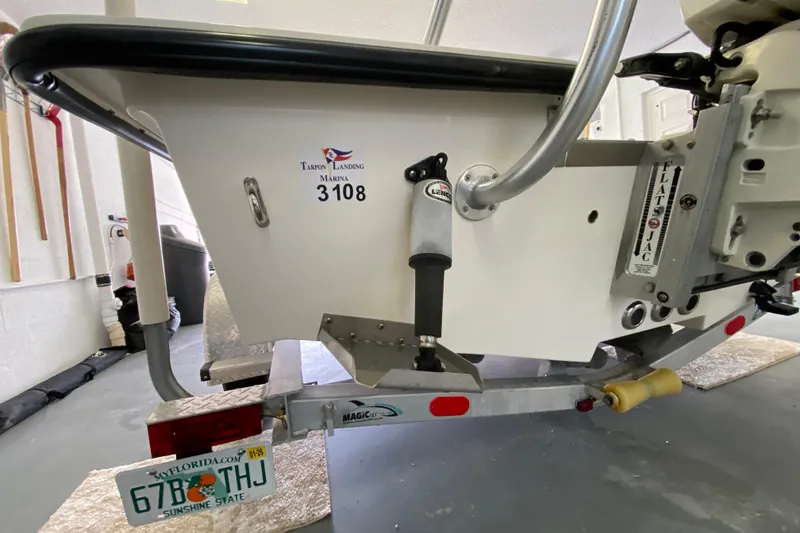 Slide: The Image of Rear view of a 2008 Famous Craft 18 boat on a trailer in a garage. - 12