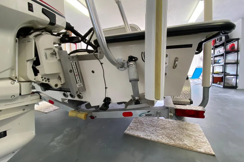 Slide: The Image of Rear view of a 2008 Famous Craft 18 boat on a trailer in a garage. - 13