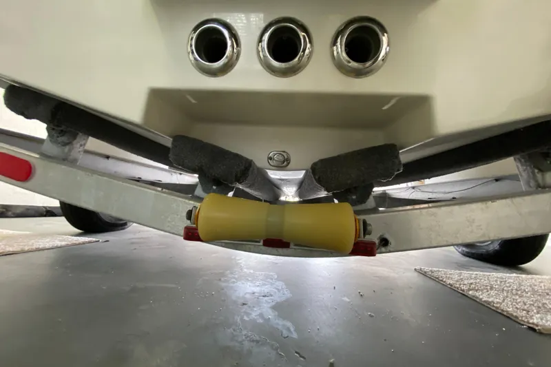 Slide: The Image of Underneath view of a 2008 Famous Craft 18 boat on a trailer. - 14