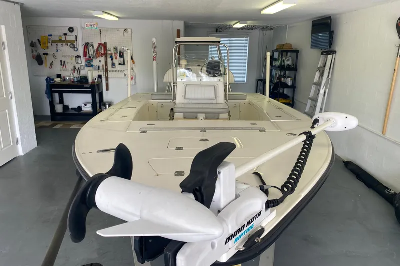 Slide: The Image of 2008 Famous Craft 18 boat in garage with tools and equipment. - 15