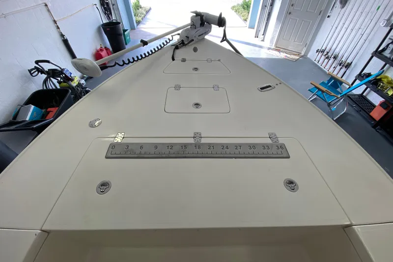 Slide: The Image of 2008 Famous Craft 18 boat deck with measurement scale in a garage setting. - 16