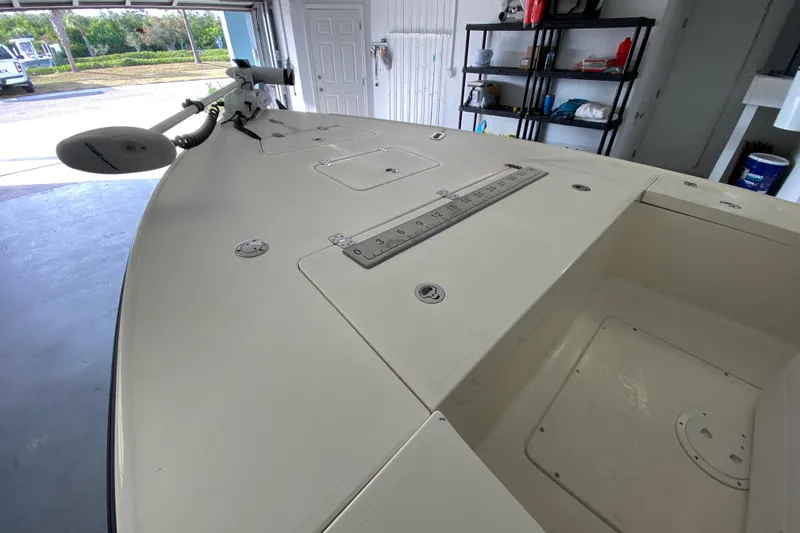Slide: The Image of 2008 Famous Craft 18 boat in garage, featuring a clean deck and mounted equipment. - 17