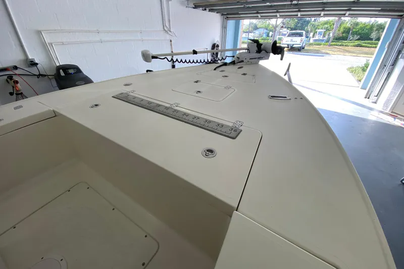 Slide: The Image of 2008 Famous Craft 18 boat in garage, featuring a spacious deck and mounted equipment. - 18