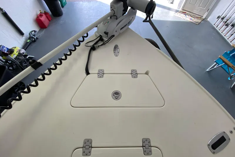 Slide: The Image of Bow of 2008 Famous Craft 18 boat with trolling motor in garage. - 19