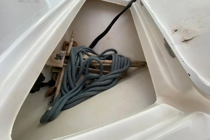Slide: The Image of Anchor and rope stored in a compartment of a 2008 Famous Craft 18 boat. - 22