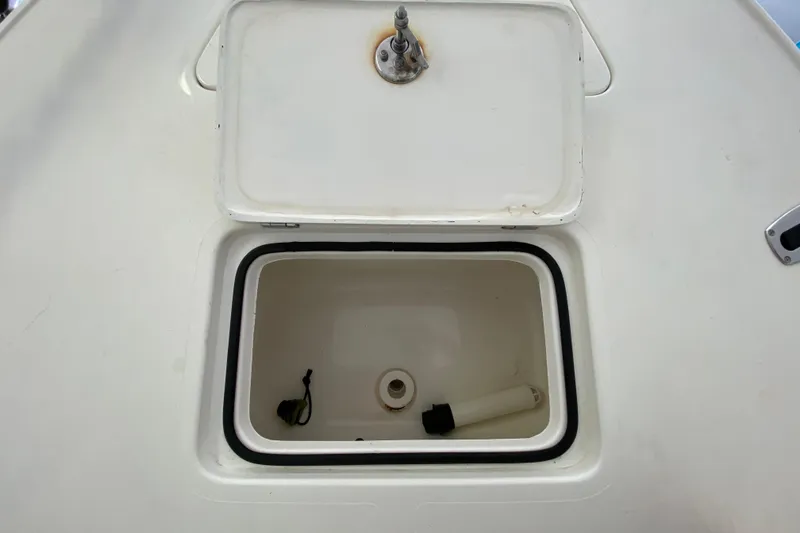 Slide: The Image of Open storage compartment on 2008 Famous Craft 18 boat deck. - 24