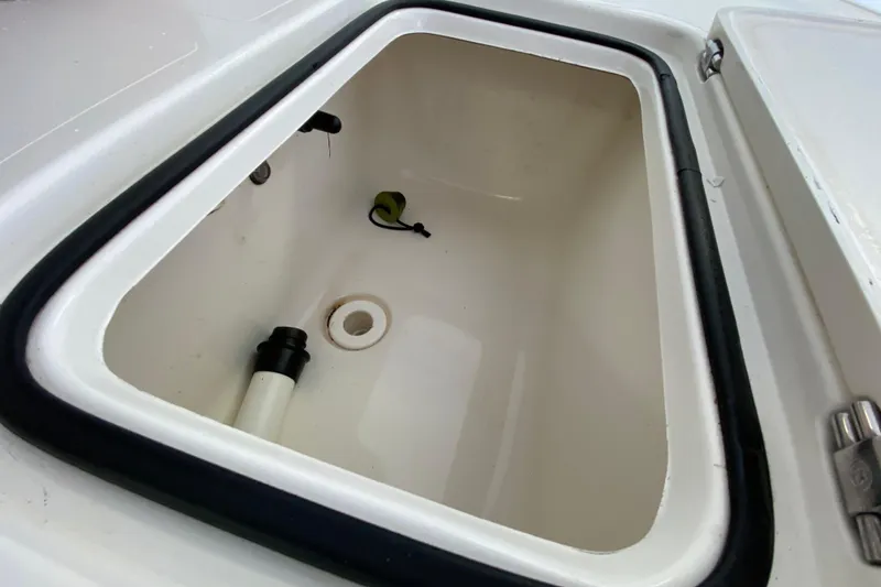 Slide: The Image of Open storage compartment in 2008 Famous Craft 18 boat, featuring a clean interior. - 25