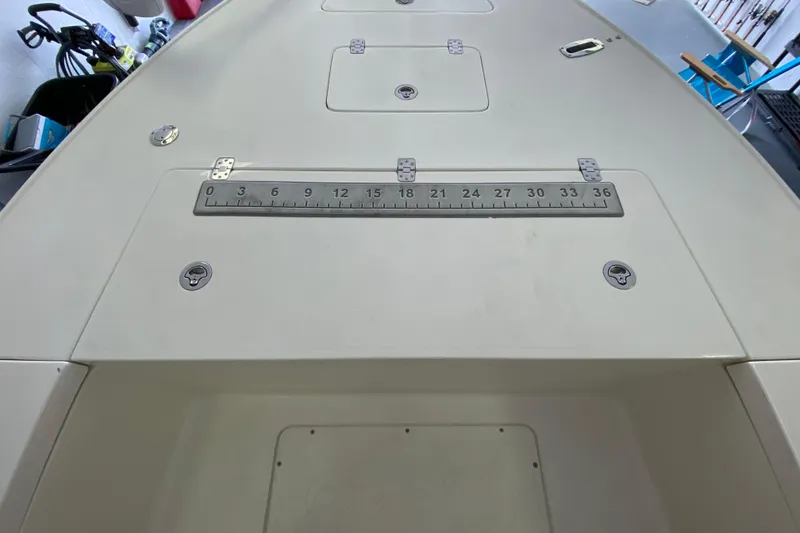 Slide: The Image of Deck of 2008 Famous Craft 18 boat with measurement scale and storage hatches. - 26