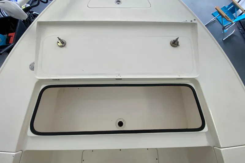 Slide: The Image of Open storage compartment on a 2008 Famous Craft 18 boat, featuring dual locks. - 27