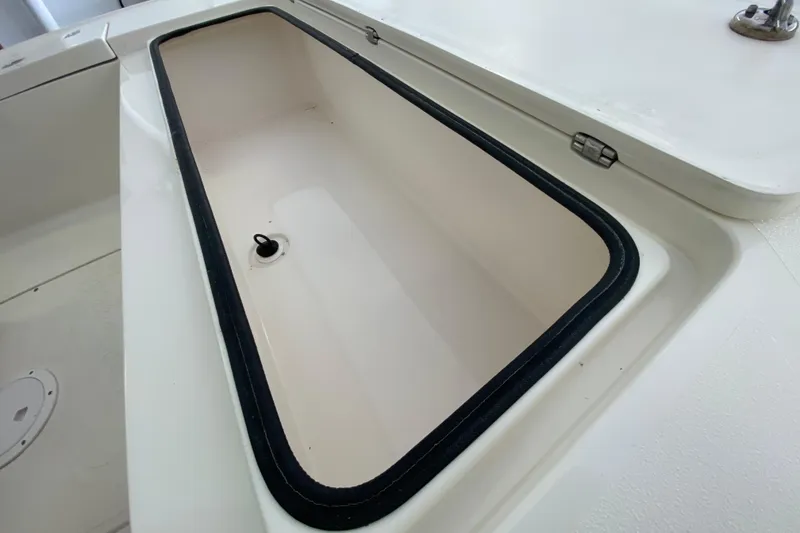 Slide: The Image of Open storage compartment on a 2008 Famous Craft 18 boat. - 28