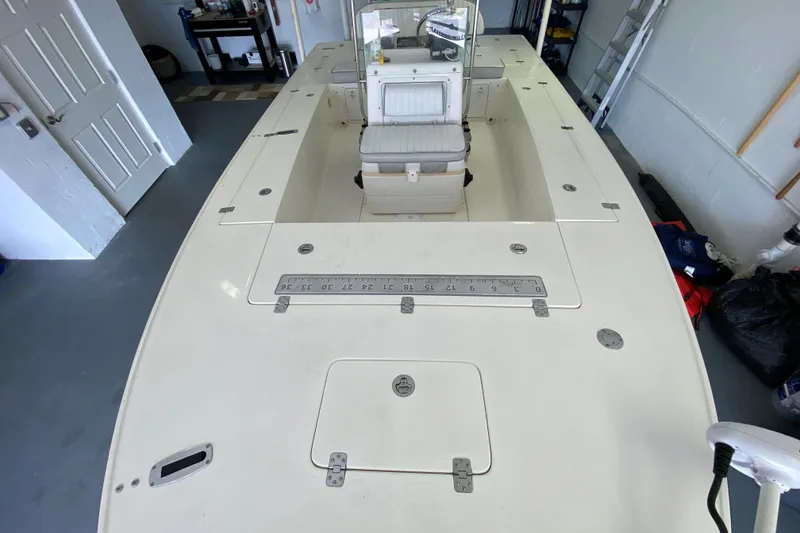 Slide: The Image of 2008 Famous Craft 18 boat in garage, featuring center console and spacious deck. - 29