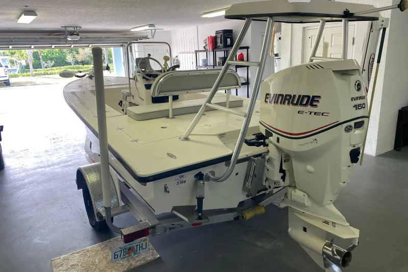Slide: The Image of Famous Craft 18 boat, 2008 model, with Evinrude E-TEC 150 engine in a garage. - 3