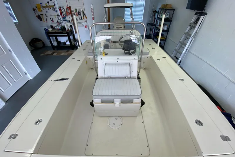 Slide: The Image of 2008 Famous Craft 18 boat in garage, featuring center console and organized workspace. - 30