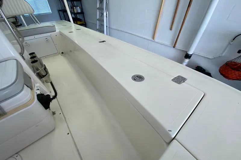 Slide: The Image of Interior of a 2008 Famous Craft 18 boat, featuring seating and storage compartments. - 32