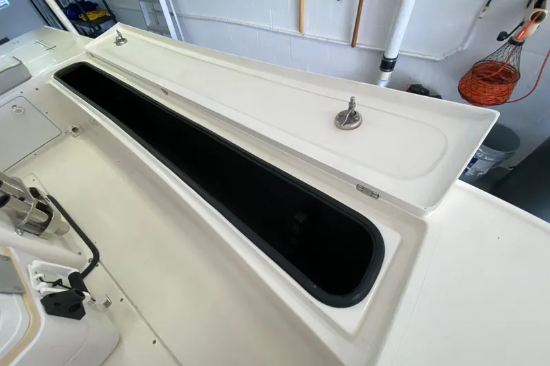 Slide: The Image of Open storage compartment on a 2008 Famous Craft 18 boat, showcasing interior space. - 33