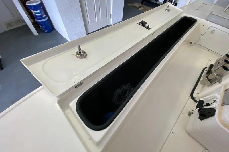 Slide: The Image of Open storage compartment on a 2008 Famous Craft 18 boat, showcasing interior space. - 35