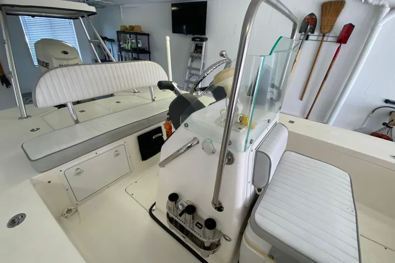 Slide: The Image of 2008 Famous Craft 18 boat interior with white seating and steering console. - 37