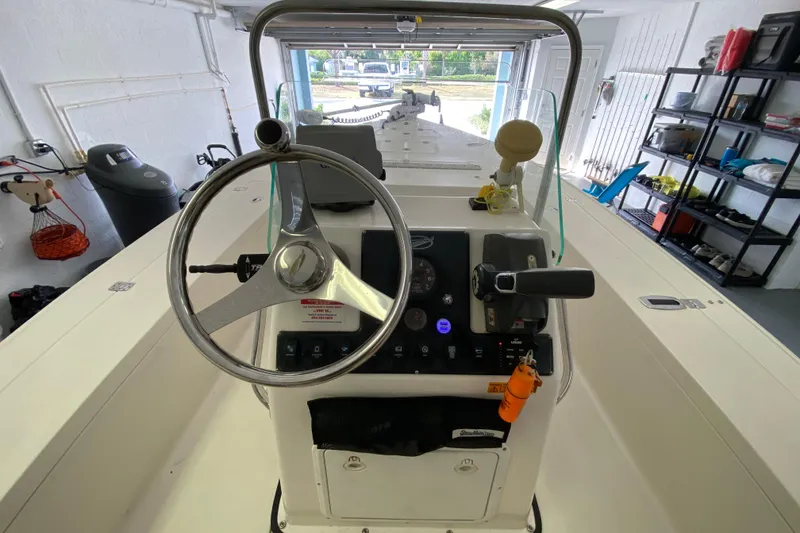 Slide: The Image of Interior view of a 2008 Famous Craft 18 boat, showcasing steering wheel and control panel. - 39