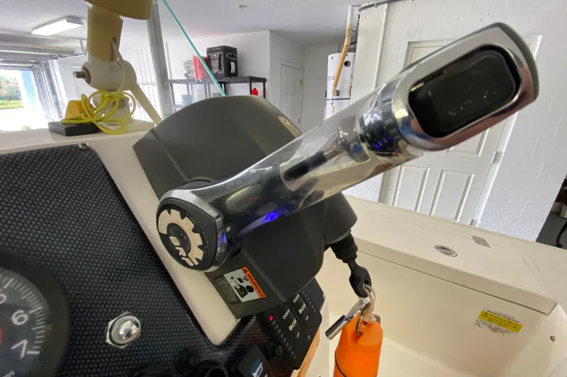 Slide: The Image of Close-up of a 2008 Famous Craft 18 boat throttle control in a garage setting. - 41
