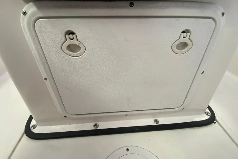 Slide: The Image of Hatch cover on 2008 Famous Craft 18 boat, featuring dual latches. - 46
