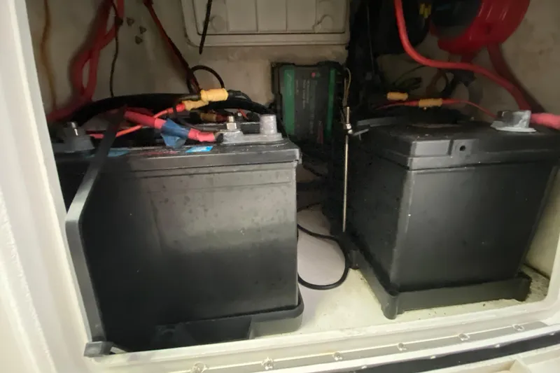 Slide: The Image of Batteries in a 2008 Famous Craft 18 boat, connected with red and black cables. - 47