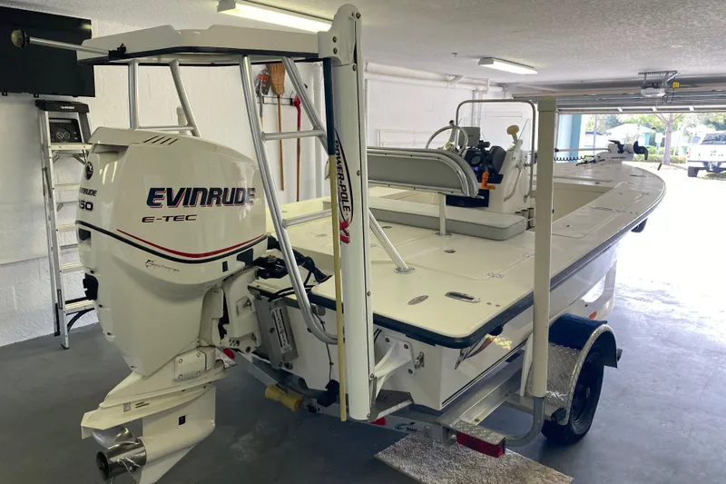 Slide: The Image of 2008 Famous Craft 18 boat with Evinrude E-TEC engine in a garage. - 5